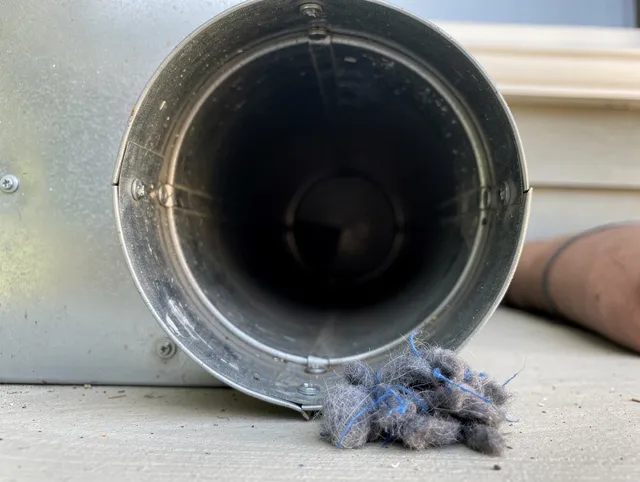 New Canaan Dryer Vent Cleaning technician using specialized equipment to clear severe dryer vent blockage in New Canaan